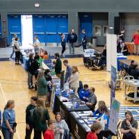 People visiting tables at career fair